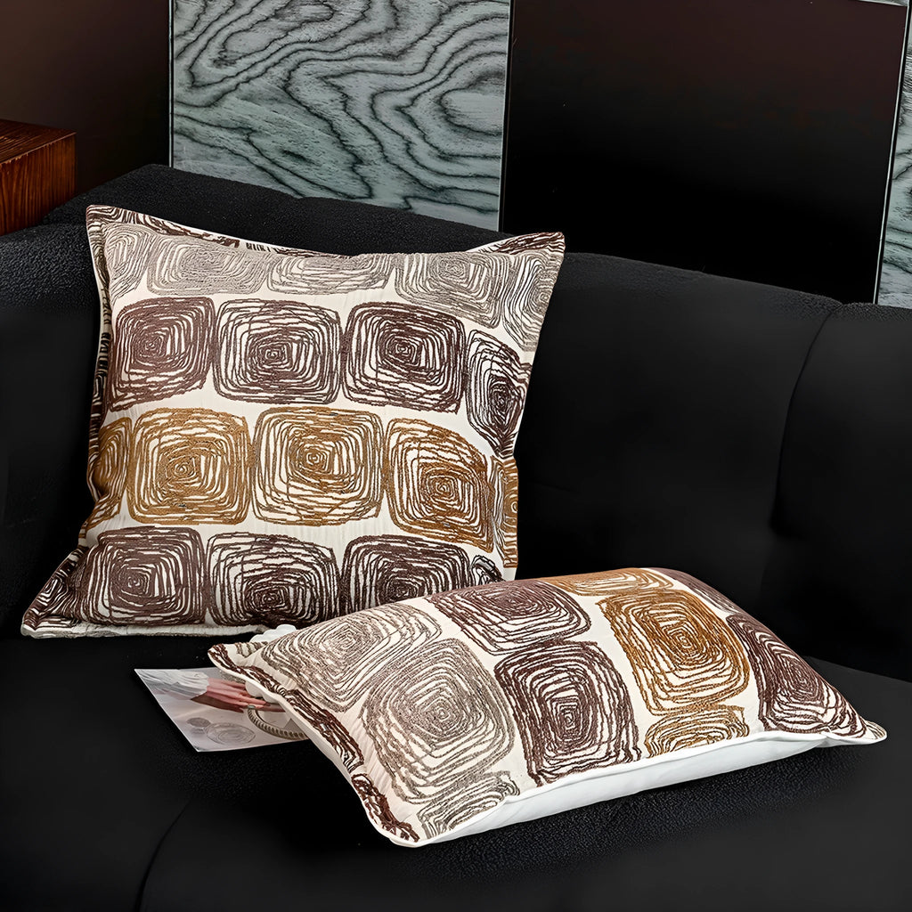 Square and rectangular pillow covers with abstract cream and coffee coil pattern on polyester fabric.