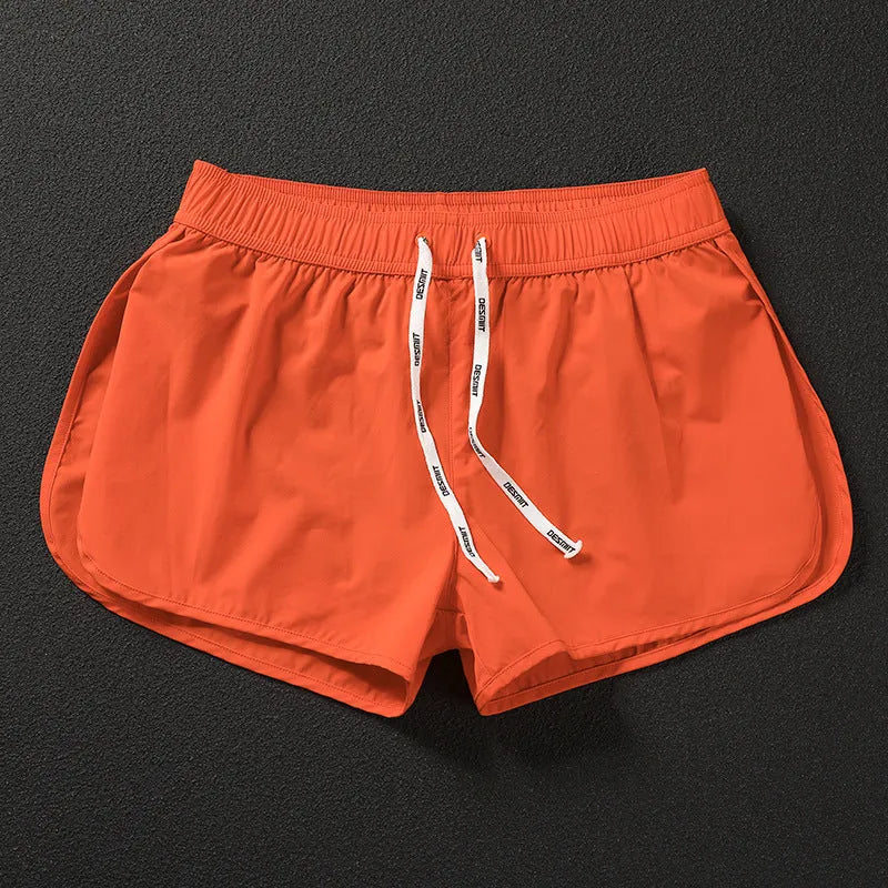 Men's loose beach shorts in orange, fluorescent green, and black colours with elastic waist