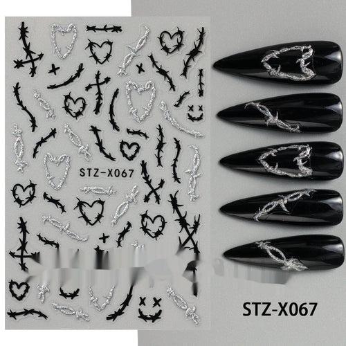 Plastic sheet of black, silver, and cartoon design nail art stickers for DIY manicures.