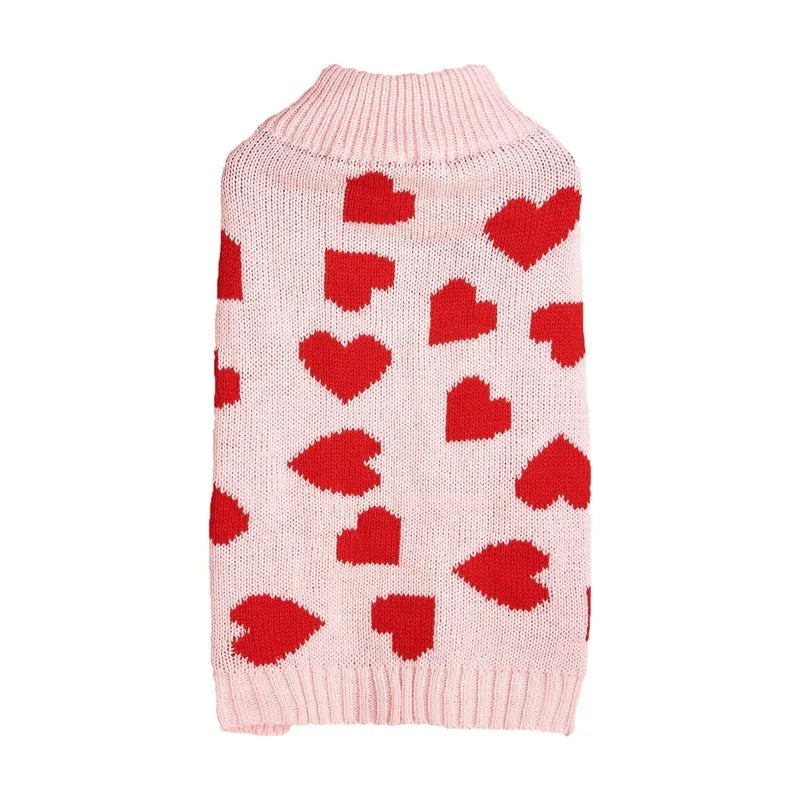 Red and pink dog sweater with love heart and bow design on a small dog.