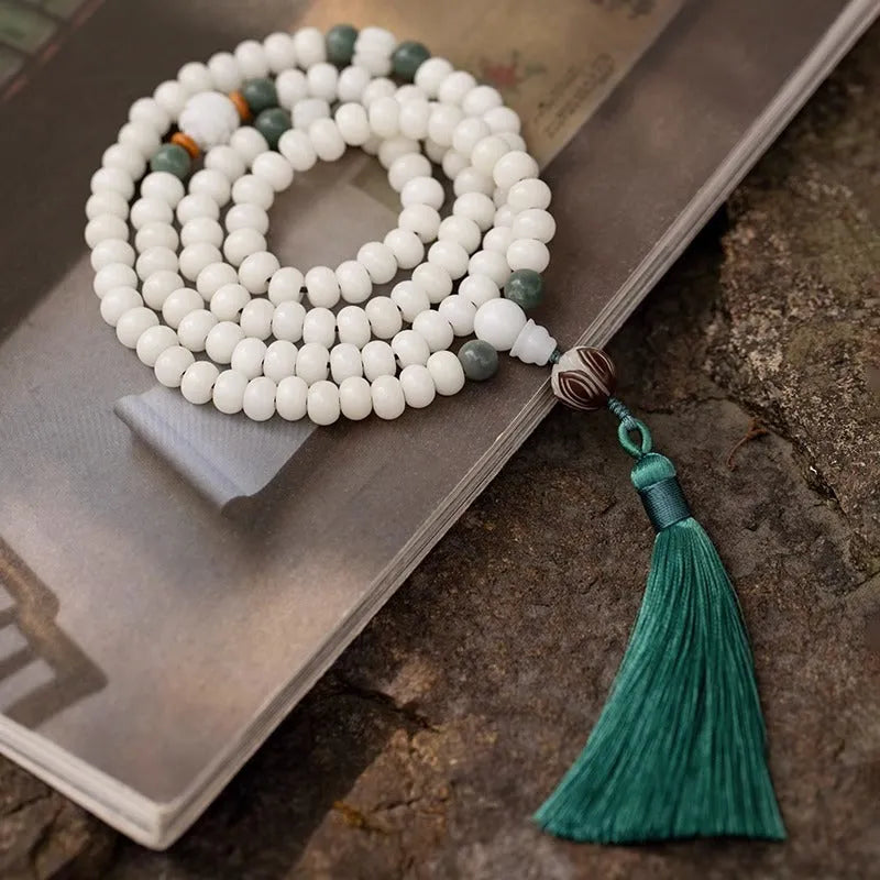 White jade Bodhi seed bracelet with 6x8mm beads showing multiple decorative style options