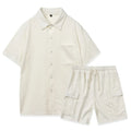 Women's beige polyester two-piece set with short sleeve top and elastic waist shorts laid flat.