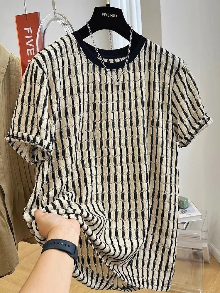 A man's loose-fitting black and white striped casual pullover shirt made from linen and silk.
