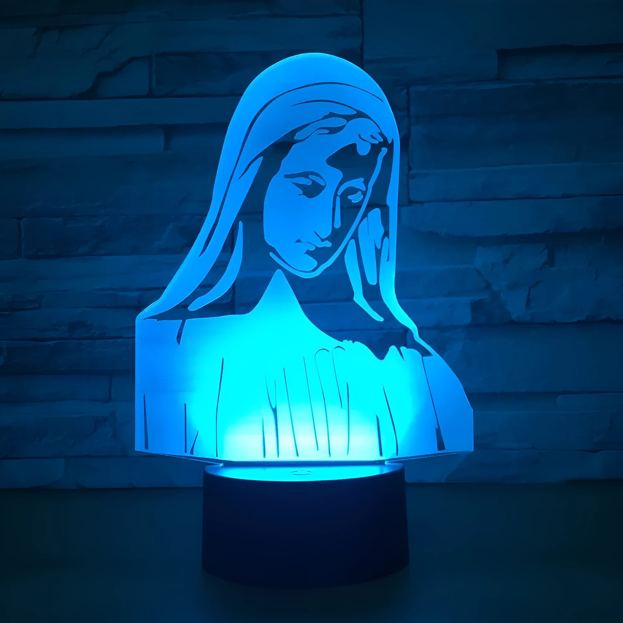 3D LED night light showing illuminated blue dual-ring pattern on acrylic plate with black ABS base.