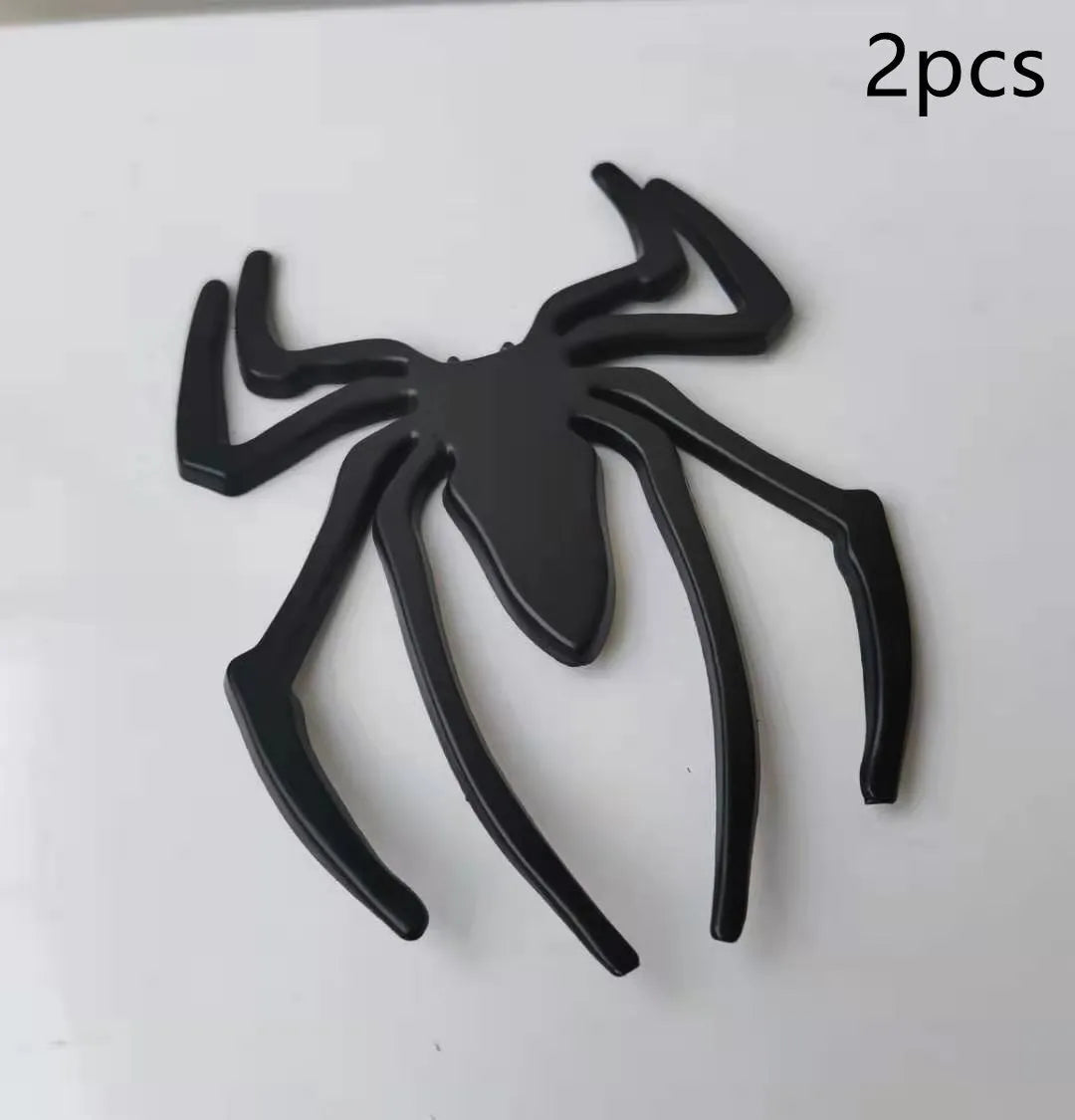 Three-dimensional metal spider sticker in gold colour, measuring 7cm by 5cm.