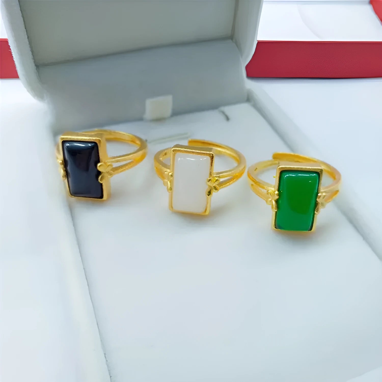Adjustable brass ring with gold plating and coloured gemstone in national style design