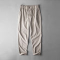 Men's mid waist linen trousers in solid colours showing trousers length and casual styling