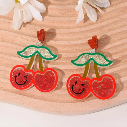 Colourful acrylic novelty earrings shaped like fruits and desserts including cherry, strawberry, and ice cream.
