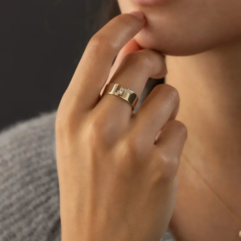 Gold electroplated women's ring with zircon stone on finger, showing copper construction and size options 6-10