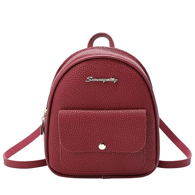 Compact black PU leather women's shoulder bag with zipper, shown next to a mobile phone for scale.
