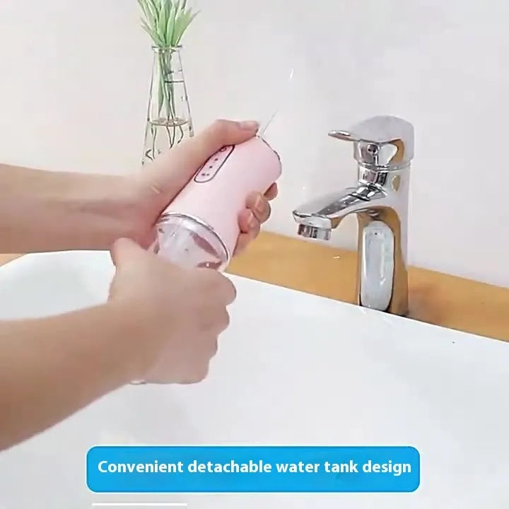 Pink electric water flosser with 300ml tank, multiple nozzles, and IPX7 waterproof design