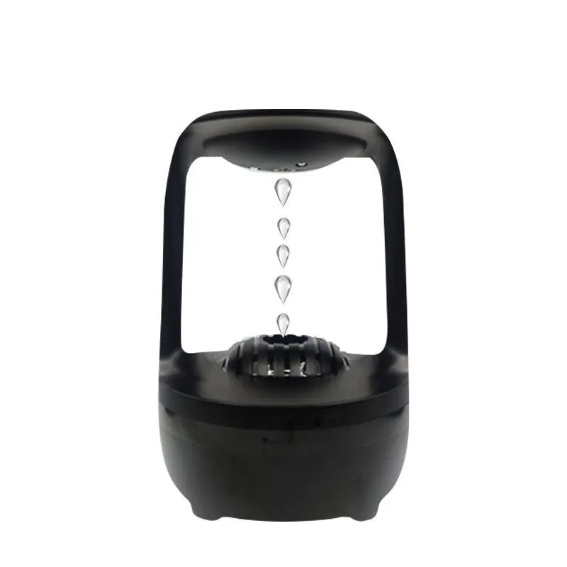 White anti-gravity water droplet humidifier on a table with USB cable, showing mist output