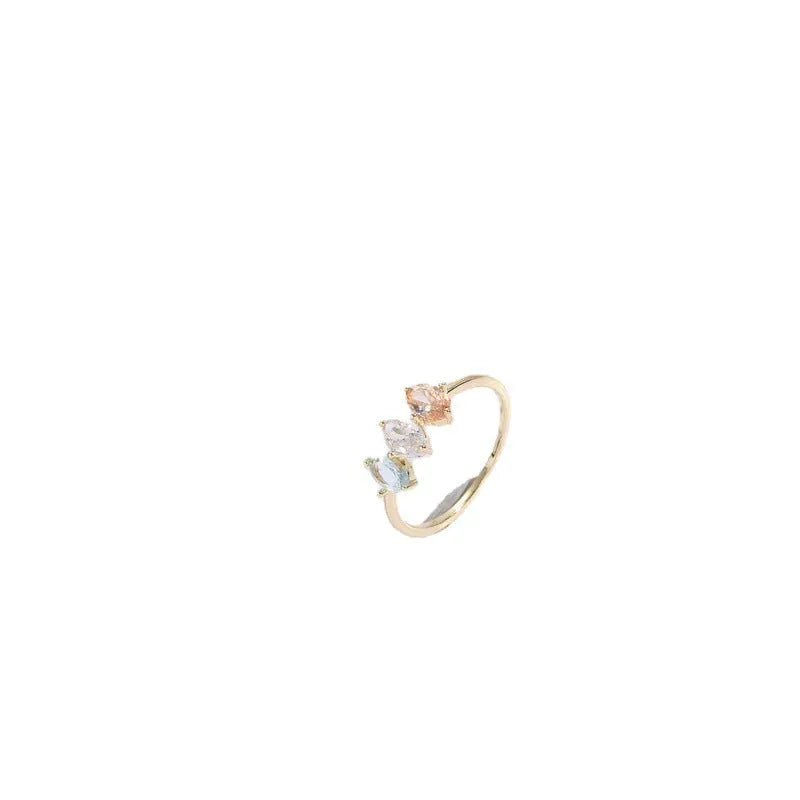 Geometric triangle birthstone ring with horse eye design and tricolour zircon stones on woman's hand