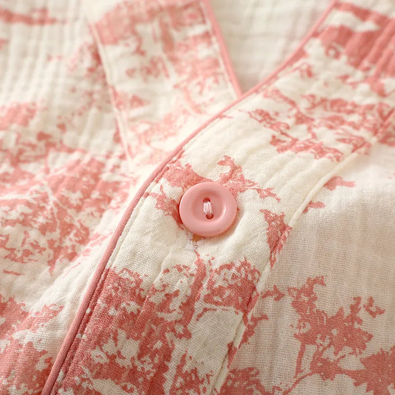 Women's pink pure cotton gauze long sleeve lounge suit top and trousers on a hanger.