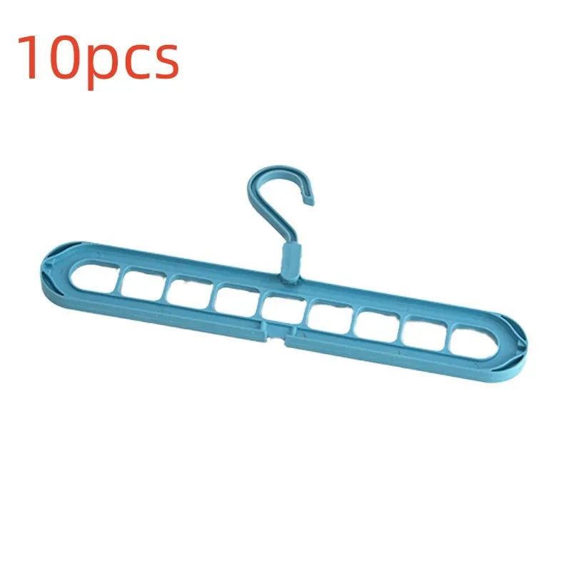 Green plastic nine-hole folding pant hanger for trousers and skirts.