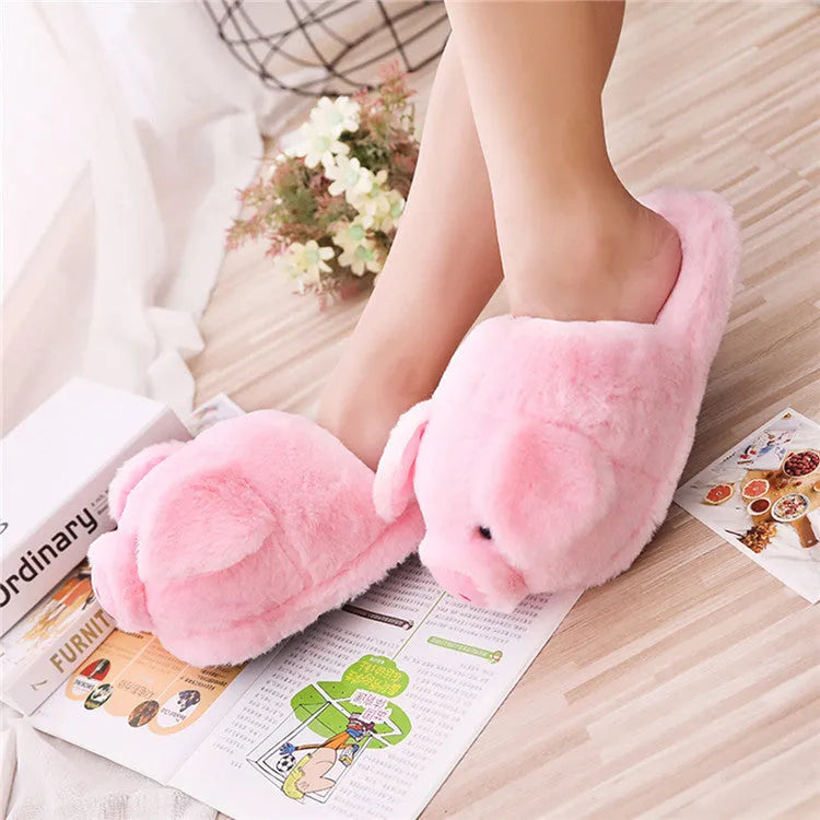 Pink pig design floor slippers with plush lining shown from side view