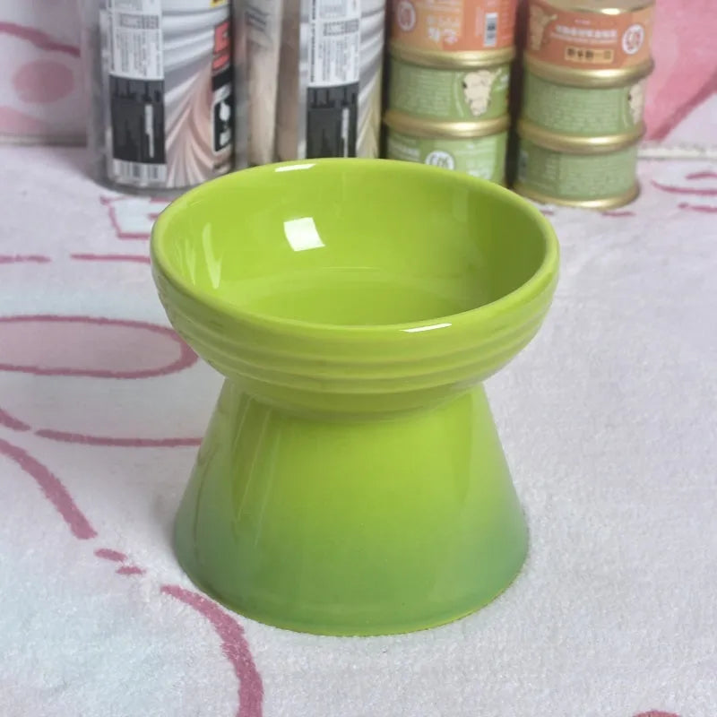 A white ceramic pet bowl with a high foot and raised neck protector to prevent tipping.