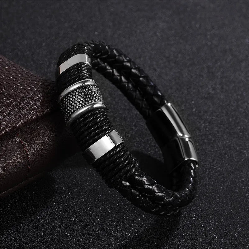 Black braid woven leather bracelet with titanium stainless steel accents for men on a neutral background