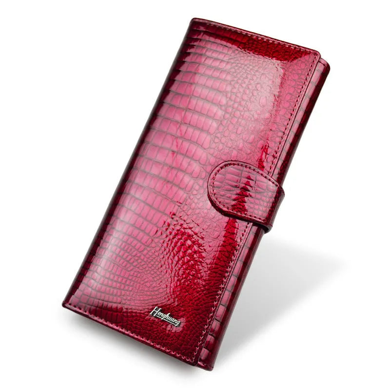 Women's red patent leather coin purse with crocodile pattern texture.