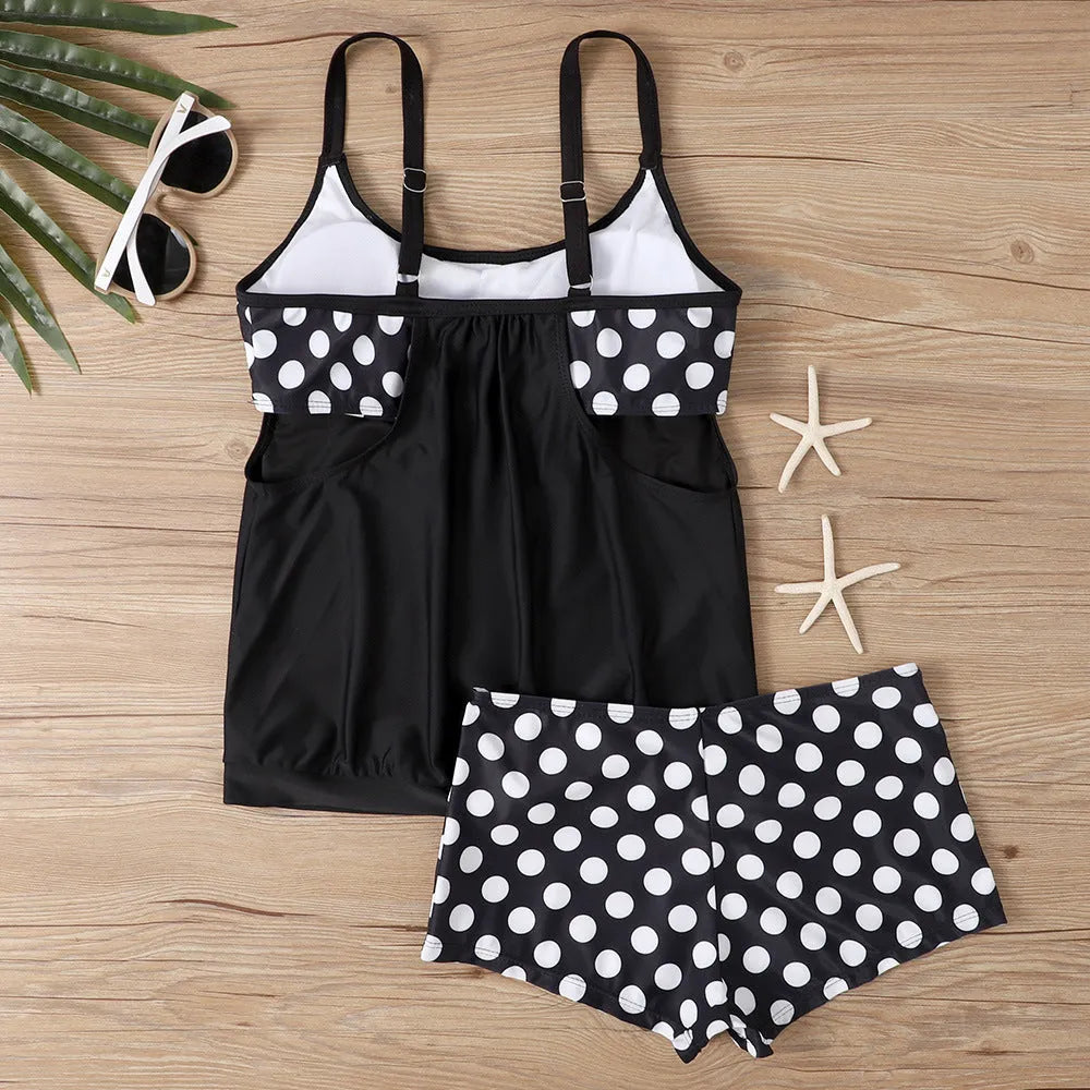 Women's black polka dot boxer swimsuit with high-waisted briefs, made from polyester fabric.