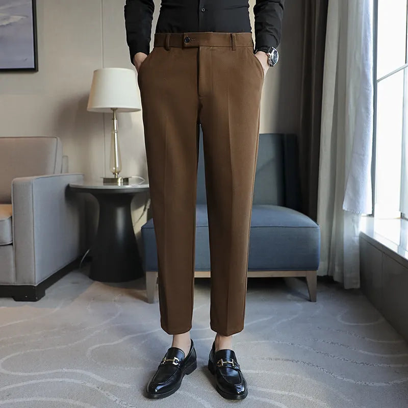 Men's straight leg brown corduroy trousers with an elasticated waistband on a hanger