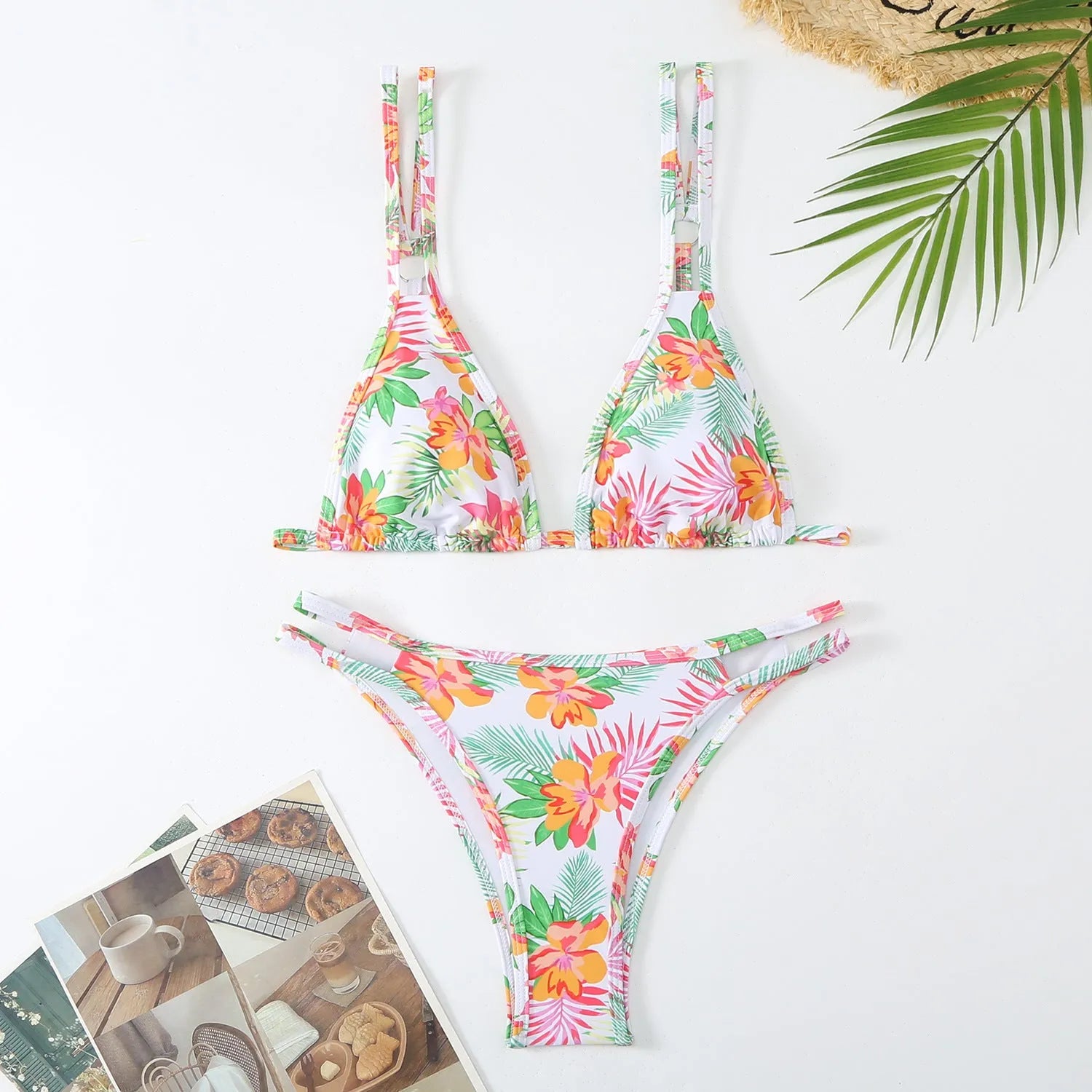 Women's printed halterneck bikini set in blue with floral pattern, showing top and briefs.