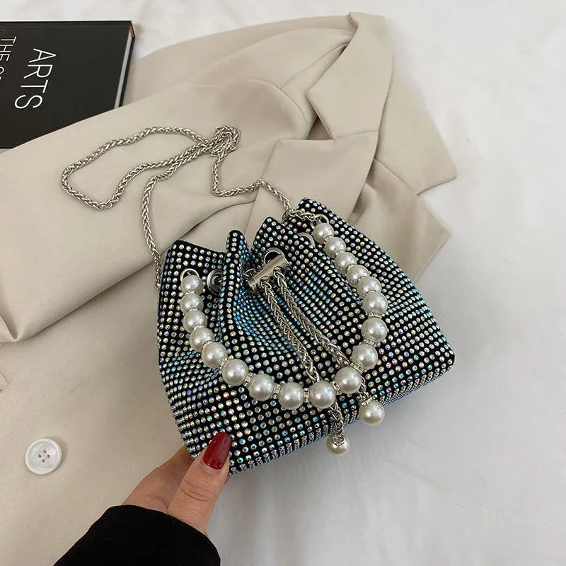 Diamond pattern crossbody bag with chain strap in bucket shape showing internal organisation compartments