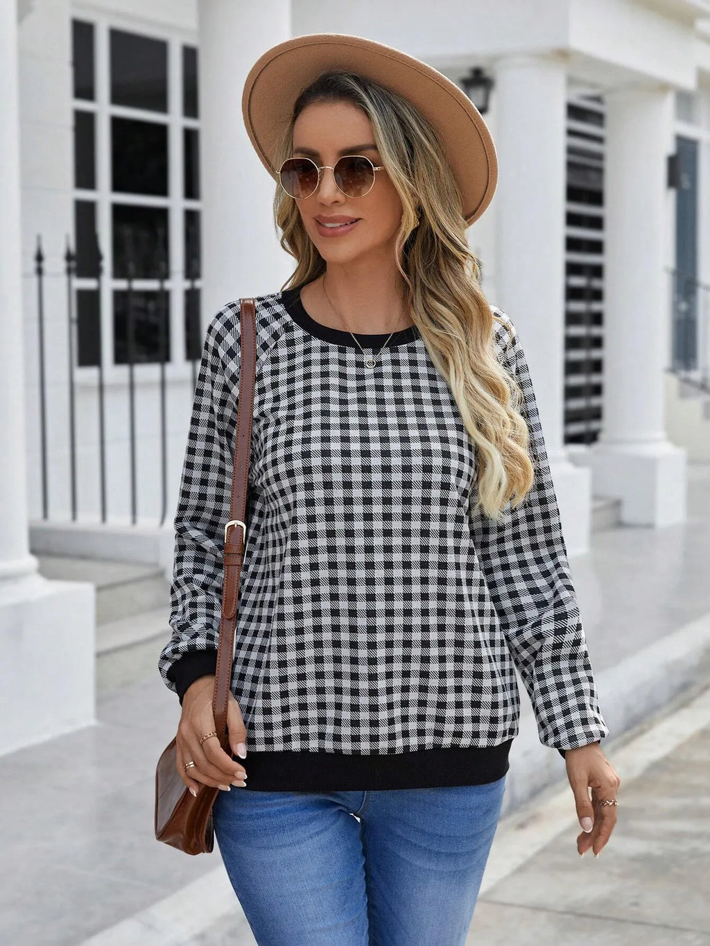 Black long sleeve pullover sweater with a striped plaid pattern and printed design detail.