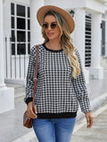 Black long sleeve pullover sweater with a striped plaid pattern and printed design detail.