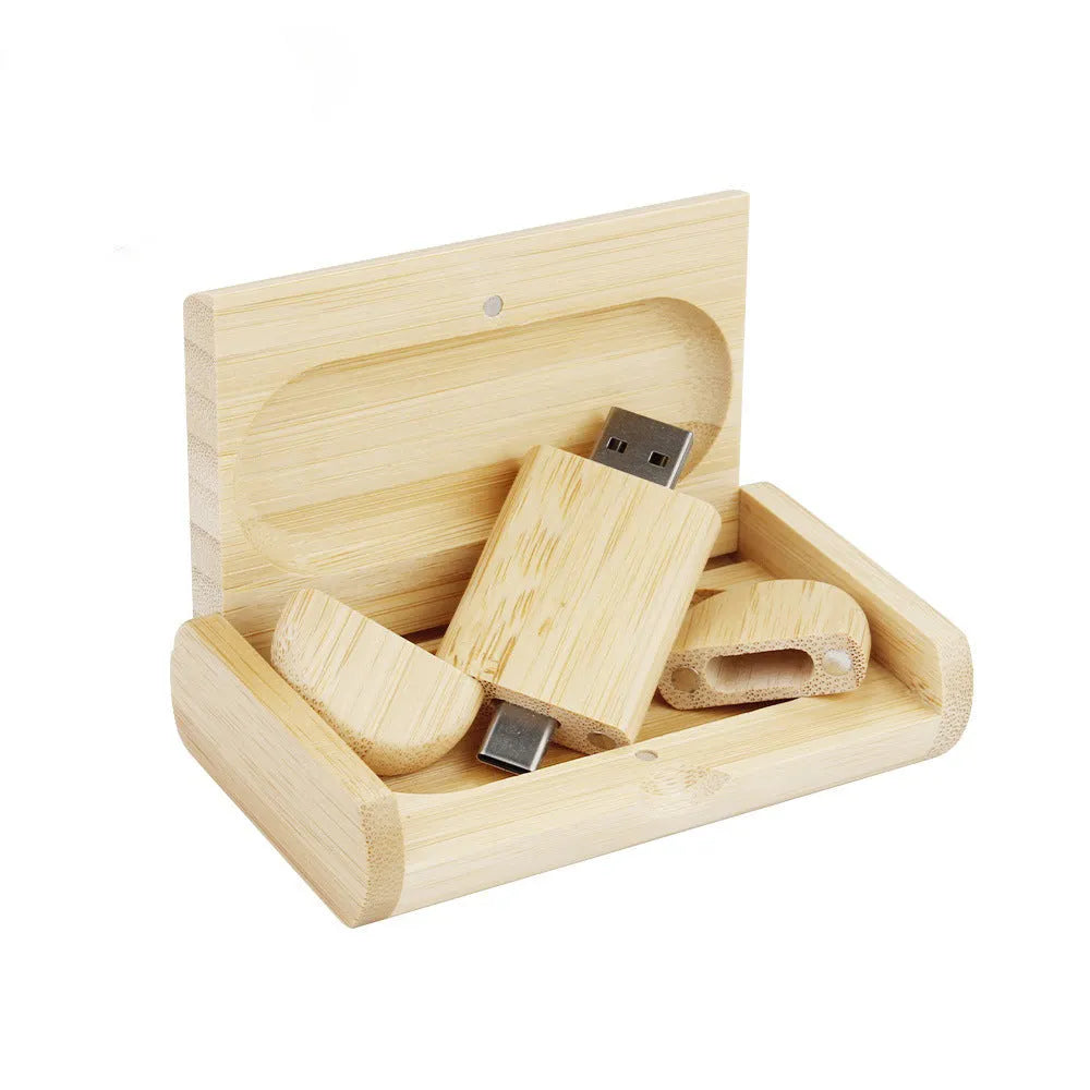 Custom engraved maple wood USB flash drive with Type-C connector for mobile phones on a wooden box.