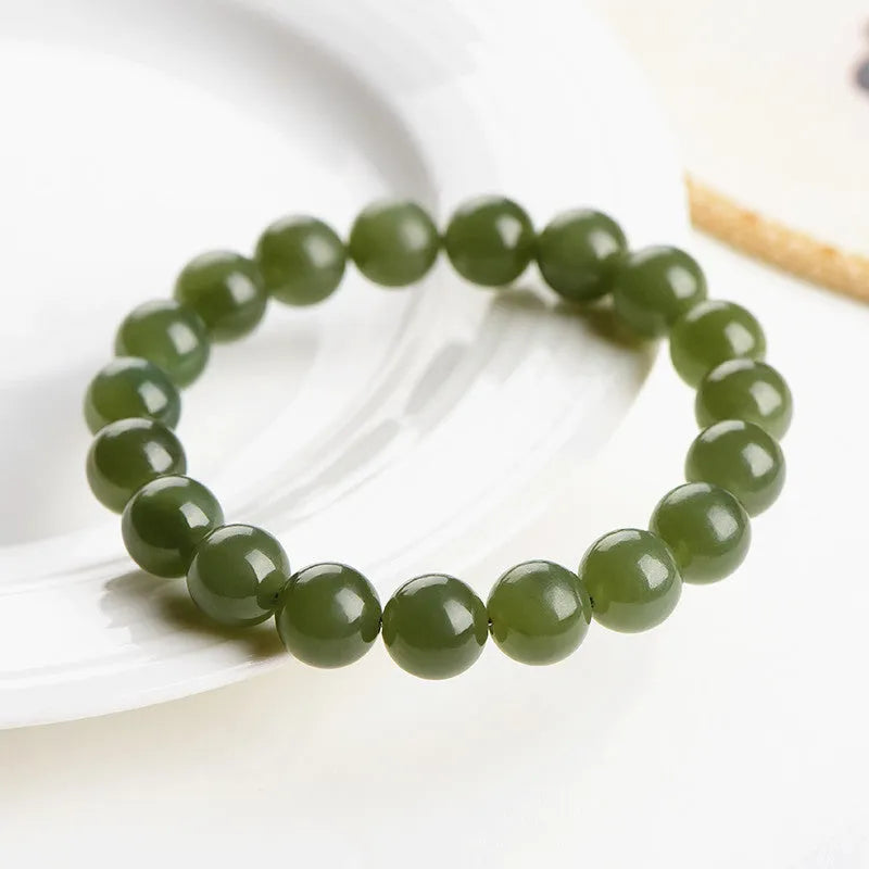 Hetian jade ball bracelet with polished spherical beads on a string, shown in deep and light clear water colour options.