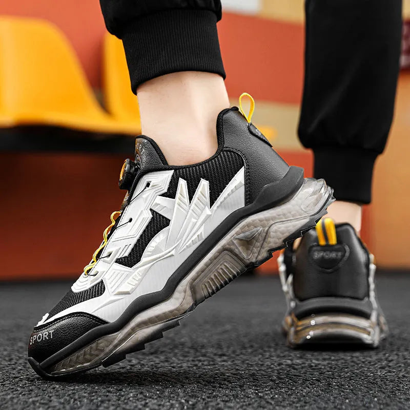 Men's black casual shoes with a rotating button closure and mesh upper on a rubber sole.