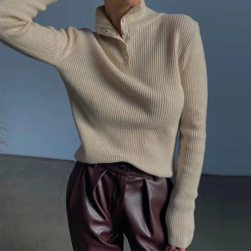 Women's silver grey slim fit pullover sweater with a half turtleneck and single-breasted placket on a hanger.