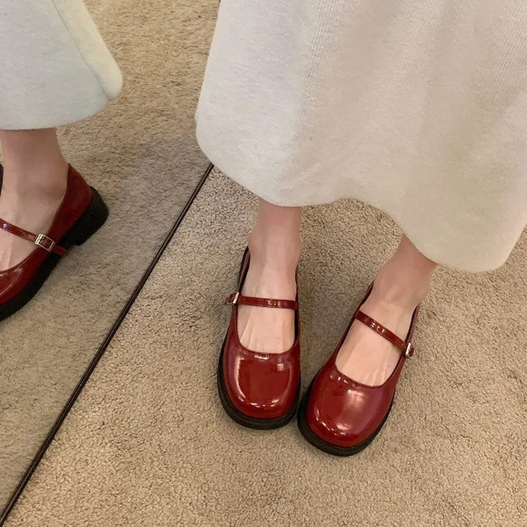 Women's solid colour French vintage flat shoes with a round toe, shown in red, black, and grey.