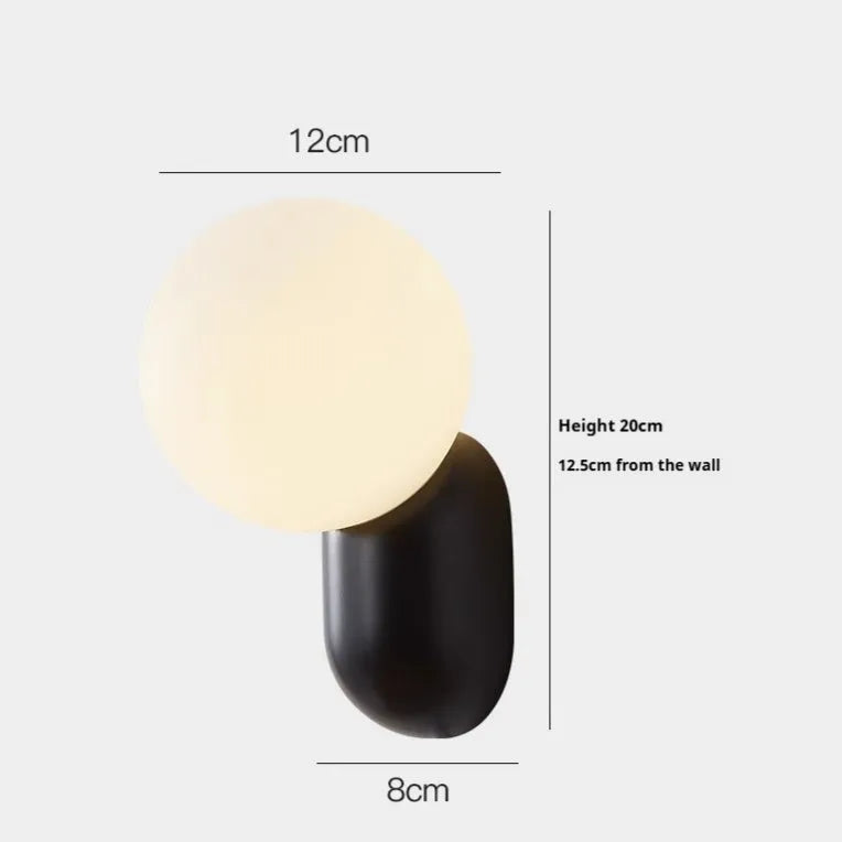 Nordic bedside wall lamp in black with acrylic shade and resin body