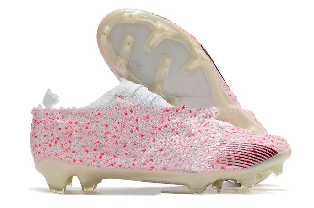 Men's low top waterproof knitted football shoes with FG rubber studs on white background
