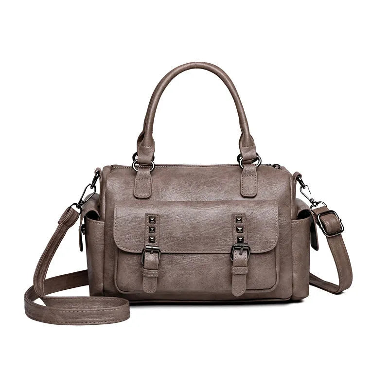 Vintage messenger bag in horizontal square shape showing contrast stitching details and shoulder strap