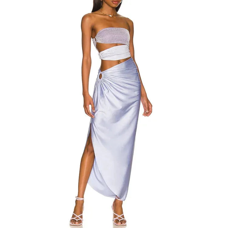 Purple one-piece swimsuit and matching wrap skirt set laid flat.