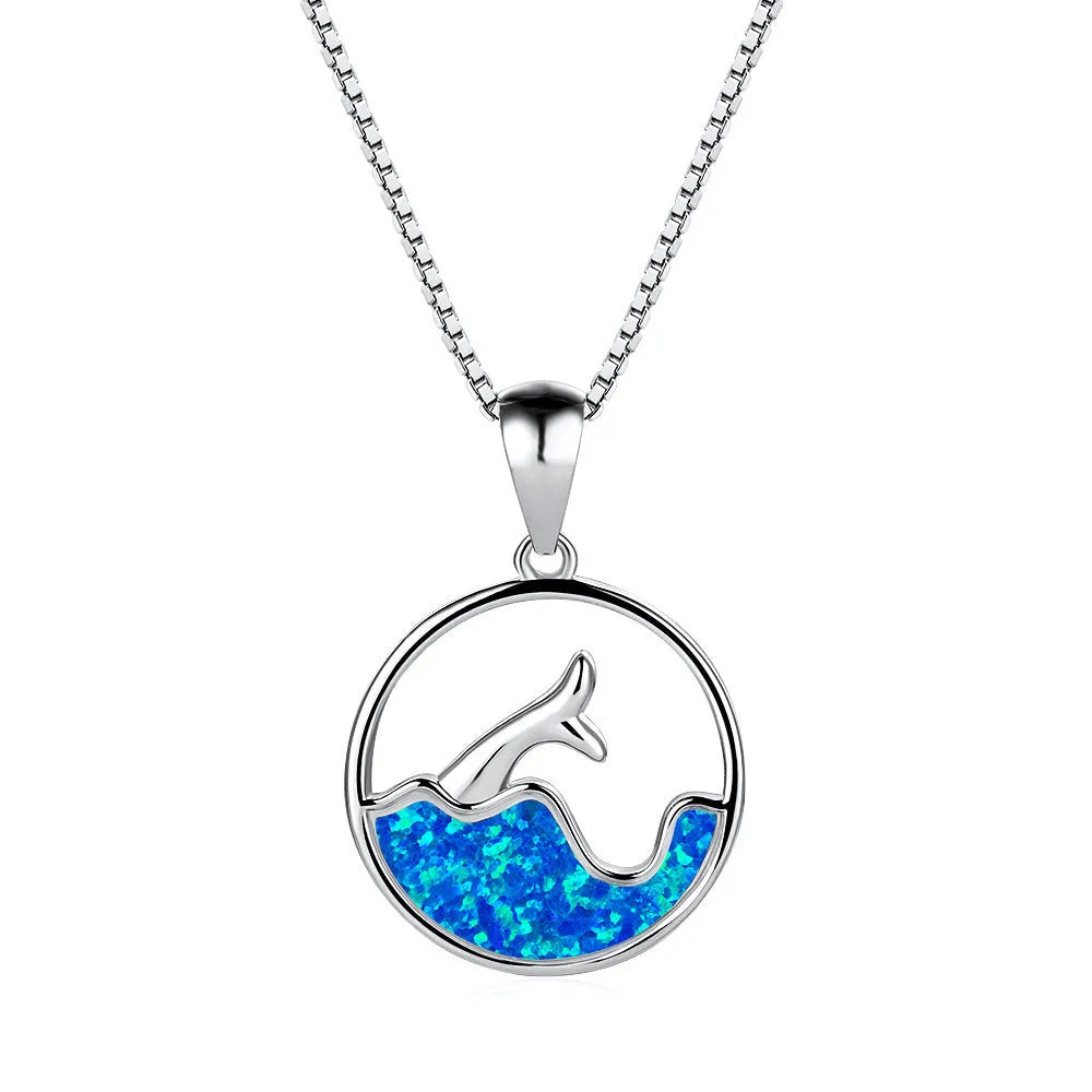 Geometric sea fishtail pendant necklace with a round blue opal stone on a thin chain.