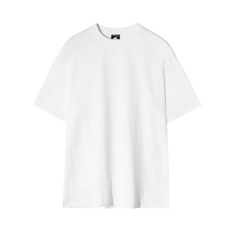 A man wearing a slim fit black cotton T-shirt with a round neck and half sleeves.