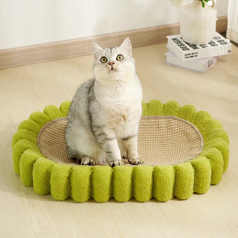 Green oval cardboard cat scratching pad with sisal surface, serving as a cat bed.