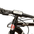 Black bicycle headlight with LED illumination mounted on handlebars