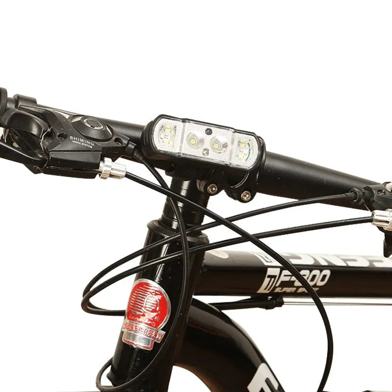 Black bicycle headlight with LED illumination mounted on handlebars