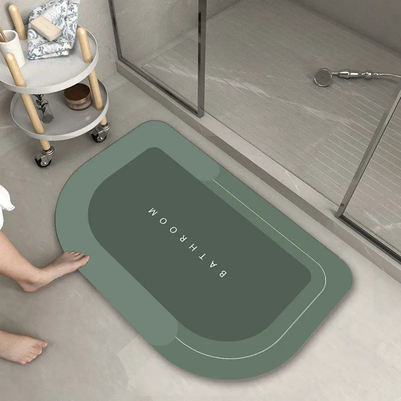 Blended fabric bathroom floor mat in blue colour, shown in an oval shape on a tiled floor.