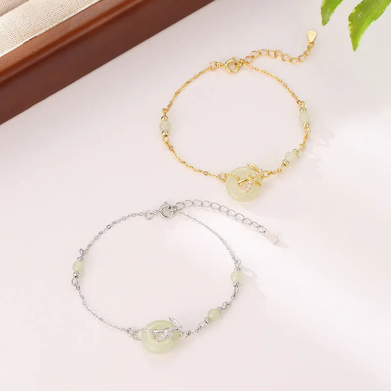 Women's antique-style silver bracelet with a peace symbol safety buckle clasp, shown in gold and silver finishes.