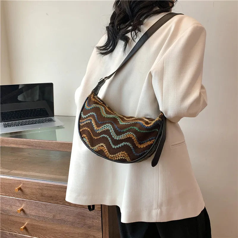 Women's straw woven crossbody bag with internal phone and document pockets in corrugated finish