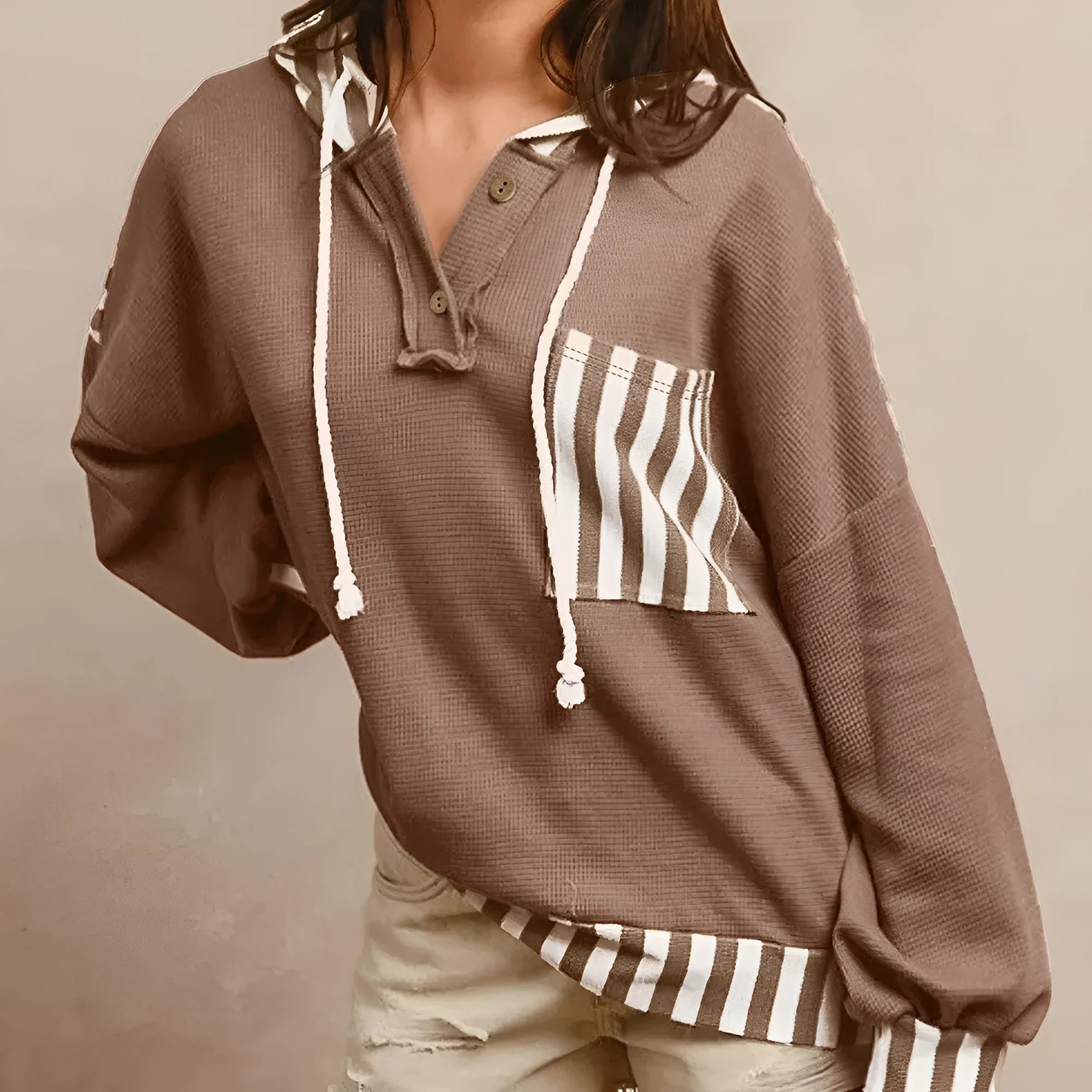 Straw yellow hoodie with waffle texture fabric, striped patchwork panels, button neck, and drawstring waist.