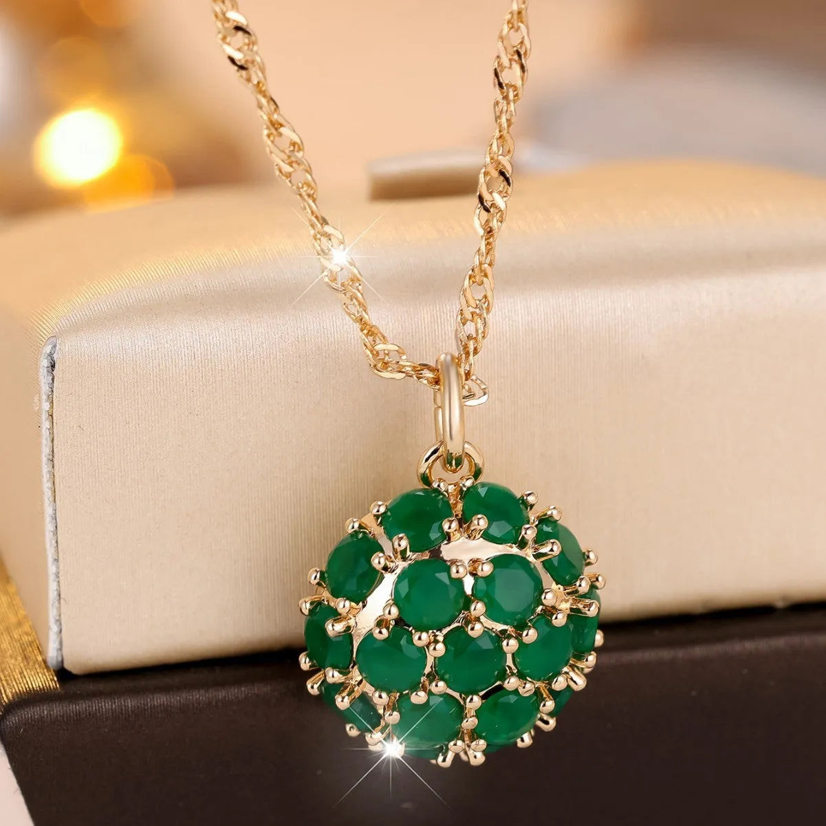 Round emerald pendant with full diamond setting on champagne gold chain necklace