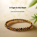 Tigereye bracelet with geometric new Chinese style design showing round beads in natural stone