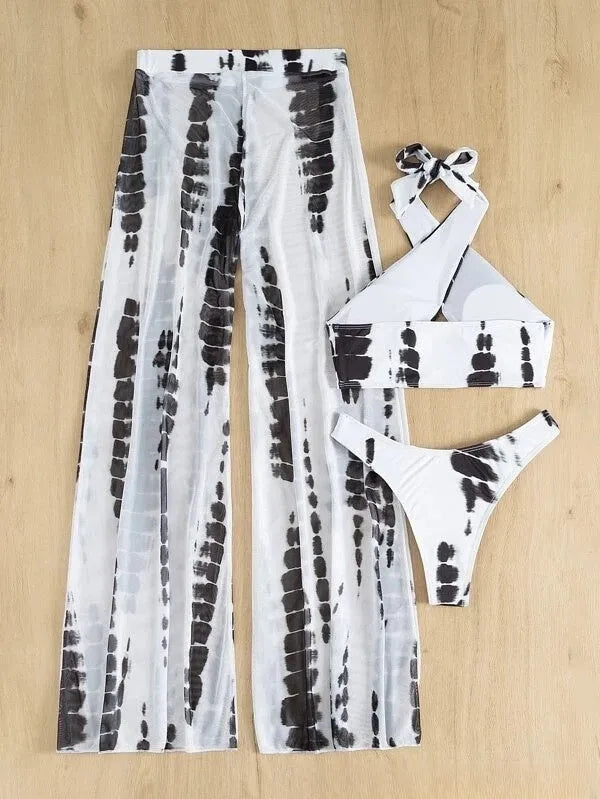 Women's black print three-piece bikini set with mesh trousers, top, and underpants on a mannequin.